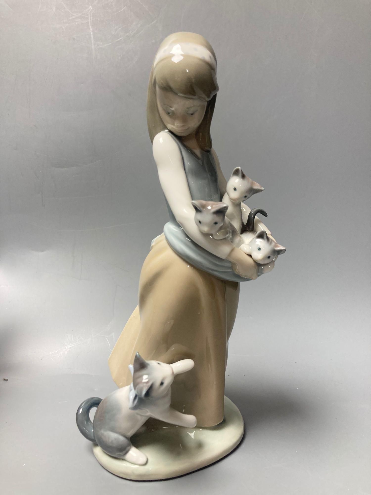 Three Lladro figures, largest 29cm, A Nao seated cherub and a Beswick horse